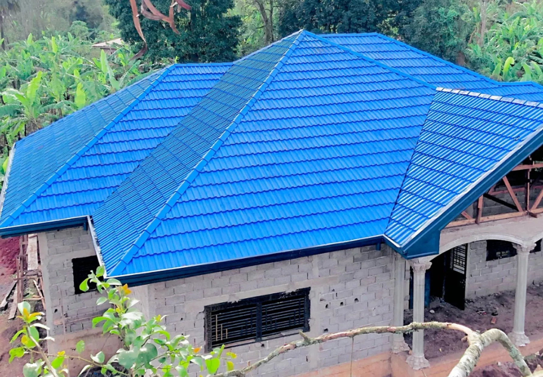 Newly installed blue stone-coated metal tile roof on a single-storey residence