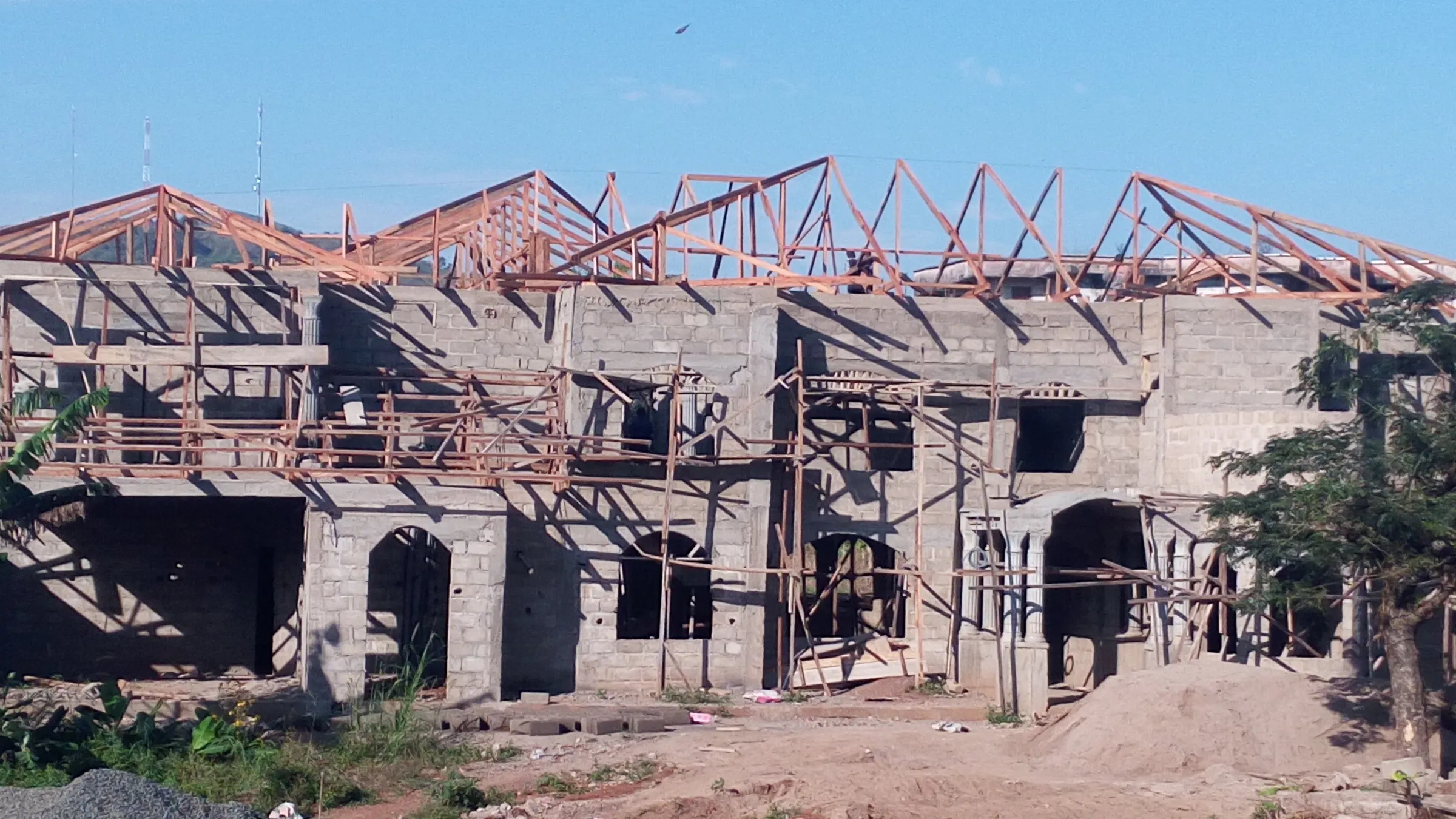 Timber roof trusses on a two-storey cement-block building
