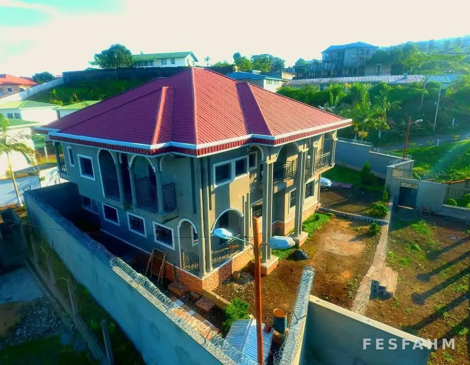 Second aerial view of the two-storey villa showing the balconies, the garden and the boundary wall
