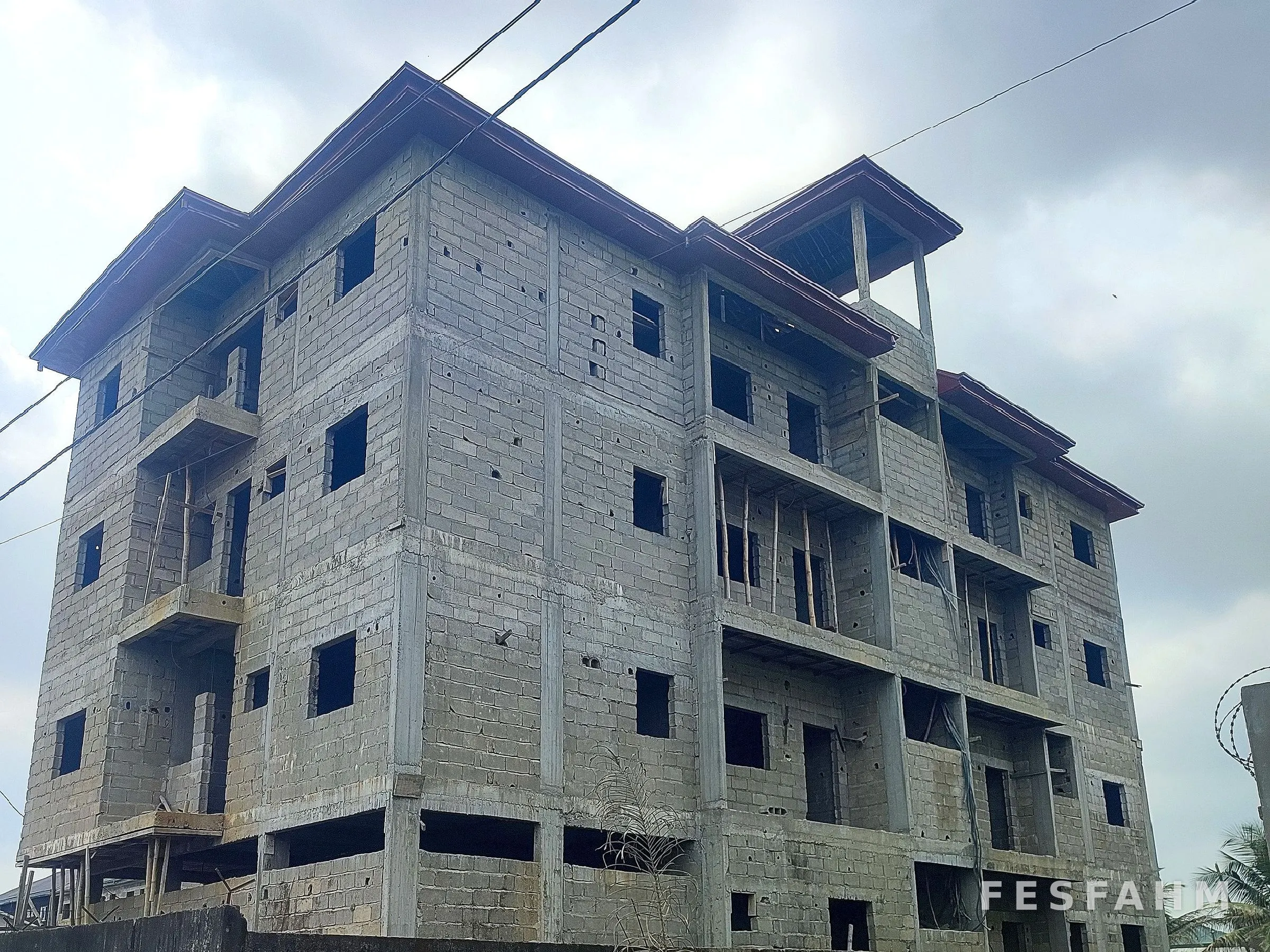 Five-storey residential block with blockwork walls complete and roof installed